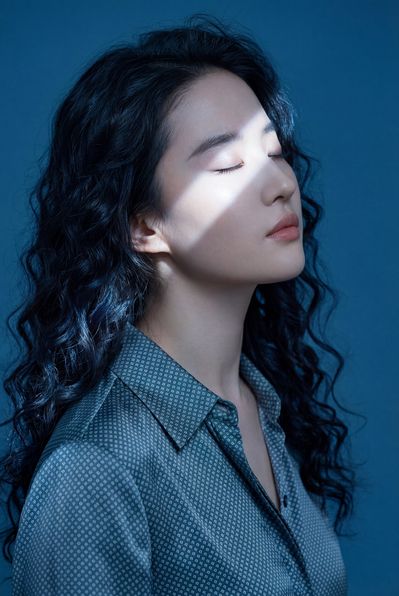 A serene portrait under blue-toned lighting